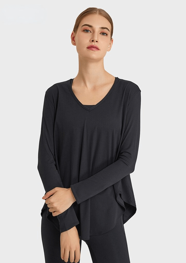 Stylish loose women's V-neck top with long sleeves, perfect for yoga. Made from a breathable nylon-spandex blend for comfort and support.
